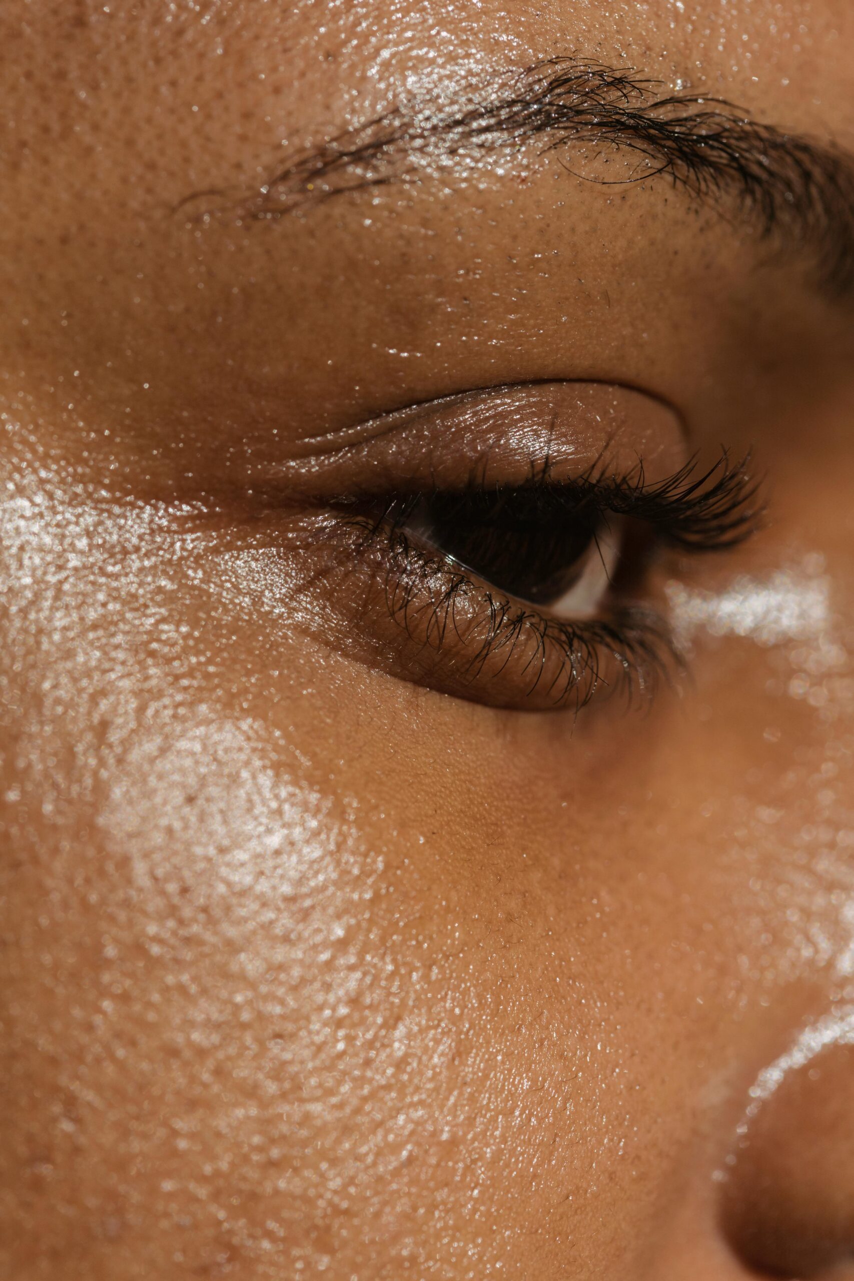 Close-up photograph of a woman's eye showcasing natural skin texture and detail.
